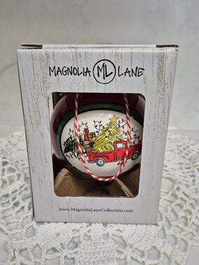 Magnolia Lane Ornament from the Collection features a truck on a red ornament